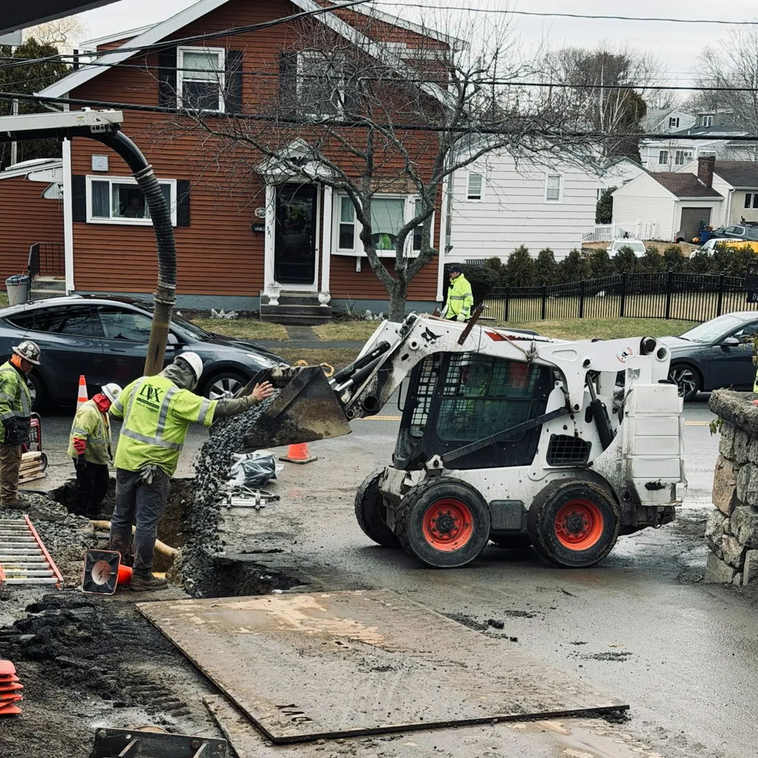 Compact equipment and workers at a residential site